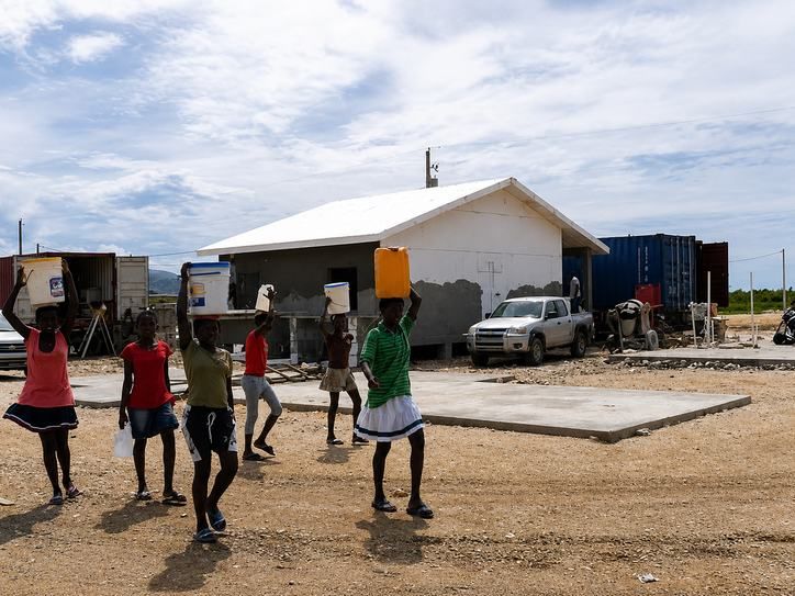 Community hands carrying materials to the build — Haiti 2011